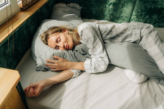 A woman peacefully sleeping on a bed, Calming Sleep Anxiety